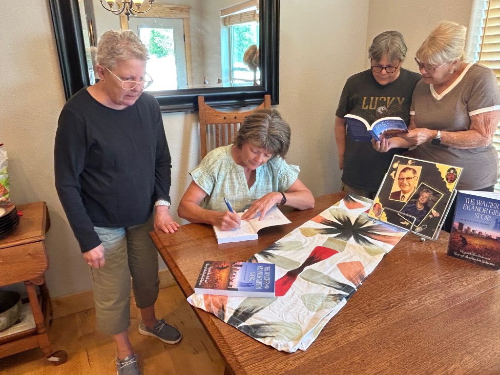 Author Sherry Gillen signing a book for readers at The Walter and Eleanor Gillen Story book signing event